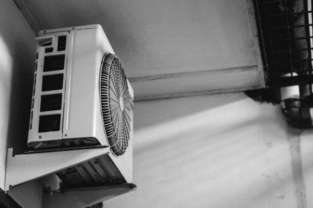a black and white photo of a wall mounted air conditioner